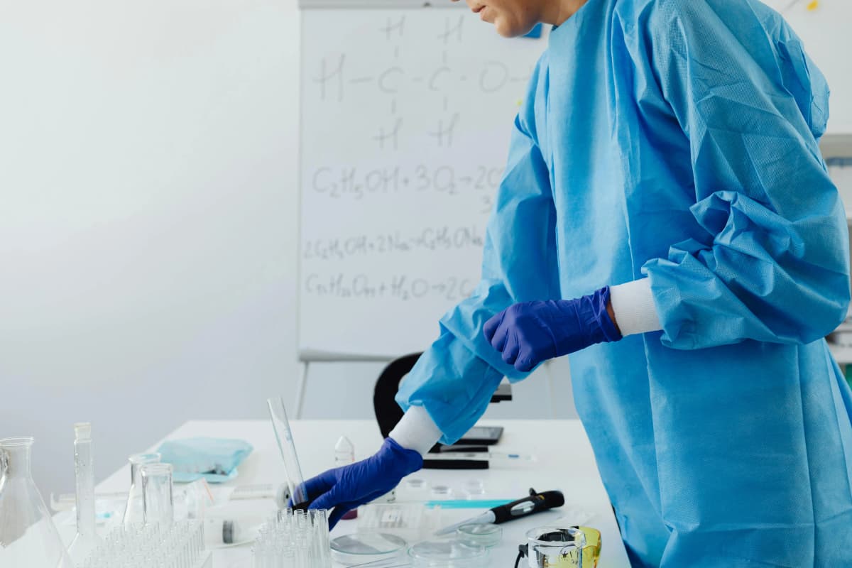 Laboratory technician in protective gear preparing samples